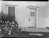 ohne Titel. (Hausfront mit Tür und Fenster auf Great Spruce Head Island, an der Küste von Maine).